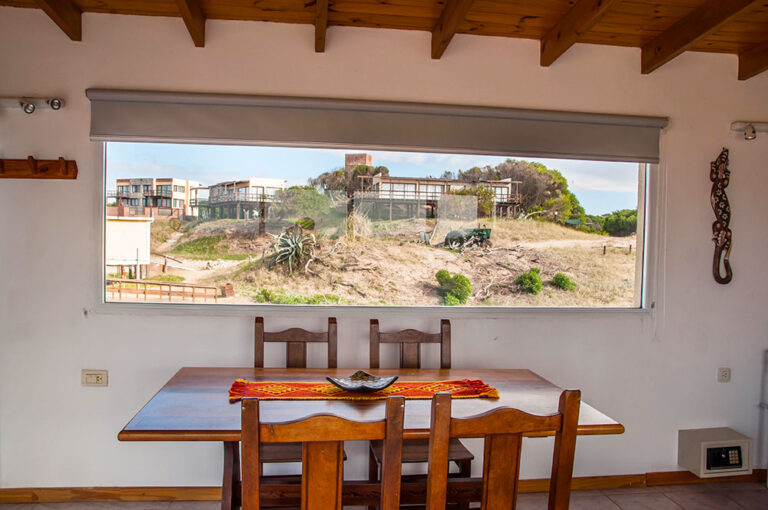 Playa Loft: mesa del comedor frente al ventanal a los médanos